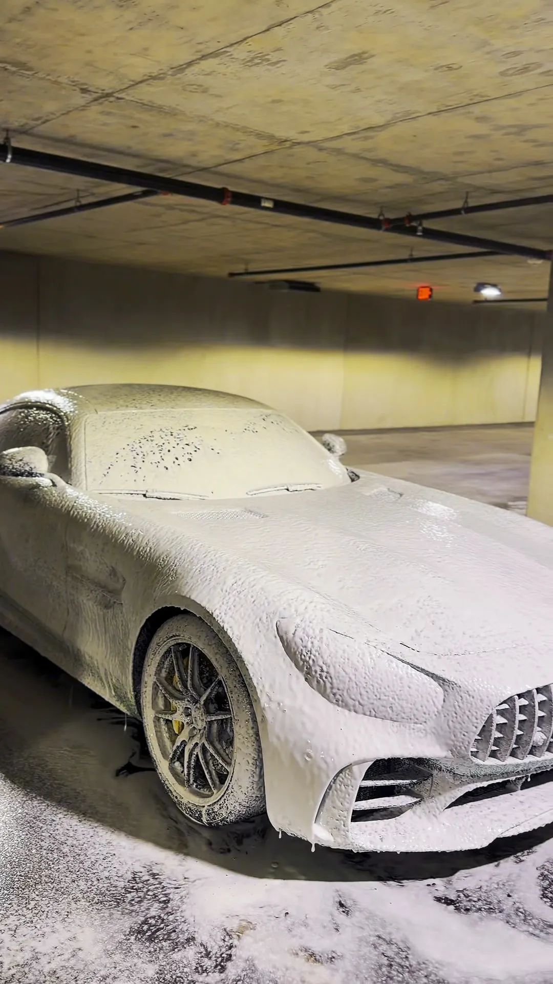 Mercedes-AMG GT covered in pre-wash foam during paint decontamination